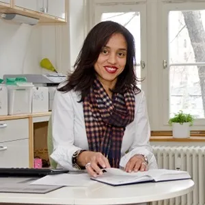 A Centrepoint volunteer at the front desk smiling at the camera