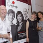 Members of the Centrepoint Board in front of a poster celebrating Centrepoint receiving Basel Stadt's Schappo award in 2017
